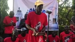 Mzee Patrick Atude on stage with Aisumunet