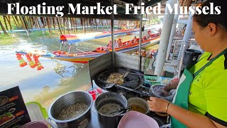 Satisfied with cooking Fried Mussels at the floating market.