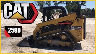 CAT 259D skidsteer pushing gravel