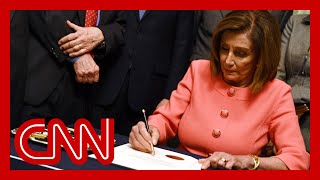 Pelosi signs impeachment articles against President Trump