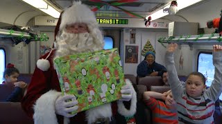 All aboard! Kids ride the rails with Santa Claus at annual event