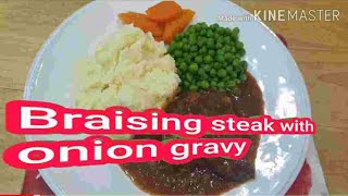 Braising steak with onion gravy.