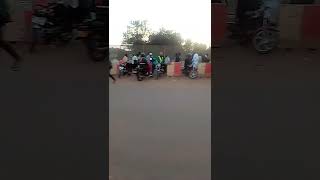 Motorcyclists on the stage in Kampala city and pedestrians heading to town.