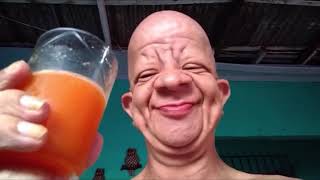 Old man drinks orange juice