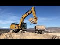 caterpillar 352f excavator loading trucks