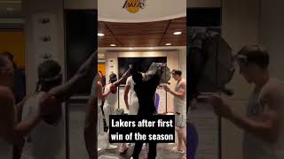 The Lakers celebrate in the locker room as if they have won a championship after their first win.