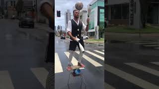 Street Performer Juggling Clubs While Balancing Himself and a Spinning Ball