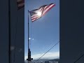 the u.s. flag flying on a remote mountain top in nw montana.