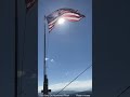 the u.s. flag flying on a remote mountain top in nw montana.