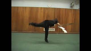 Wushu butterfly kick with sword