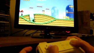 Playing New Super Mario Bros. Wii using my modded Wiimote with a bigger d-pad and buttons.
