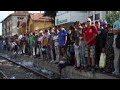 Migrants flood train platform