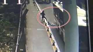 Boy narrowly escapes being run over by bus after tripping over guard rails