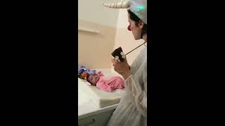 Doctor singing a song for baby