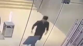 Man runs through a glass door