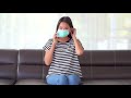 Young Asian woman putting on a medical mask   Free HD Video Clips