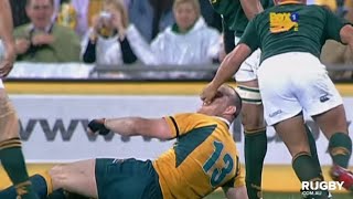 Stirling Mortlock cops a face rub from Ricky Januarie - 2006