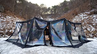 Awning tent camping with urethane windows in the frozen mountains due to strong winds