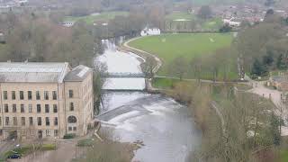 Aerial footage of Roberts Park and Salts Mill Weir, Saltaire