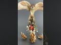 collectible owl sculpture with a fire butterfly made of air clay. ooak