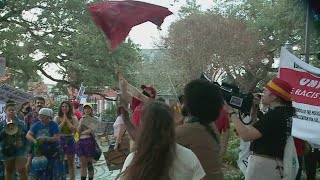 People protest as President Trump arrives in New Orleans for historic Super Bowl visit