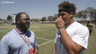 Clarence Hill goes one on one with Cowboys fullback Keith Smith