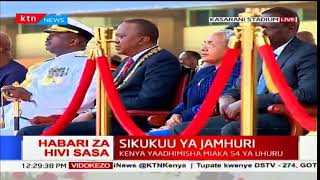 Military personnel parade in front of President Uhuru Kenyatta during Jamhuri day celebrations