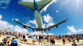 Plane taking off in runway creating sand storm and deafening noise. Beach airport. Airport video.