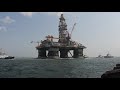 the world s largest oil rig platform the noble jim day being moved back to sea through port aransas