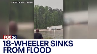 18-wheeler goes off road, submerges during heavy flooding in Houston area