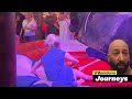 girl in blue denim dress riding on a mechanical bull in benidorm 4k