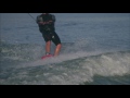 slow motion shot of a wakeboarder who does a 360 degree turn