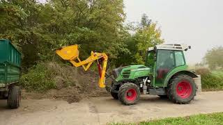 Fendt Vario 209F & Ilmer Hecklader beim Anhänger beladen.