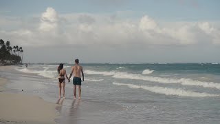 Couple Walking Along The Beach Stock Video