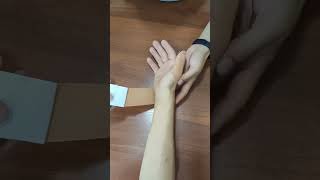 Fixation of the thumb using kinesio tape.