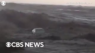 Cars wash into the sea as \