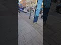 UK England's 2 Cyclists Wearing All Black. A Male Riding A Scooter. CARS