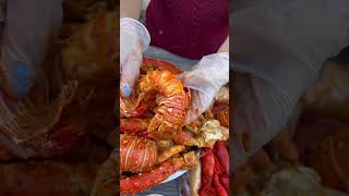Top-ranking seafood boil : indulge in juicy lobster tail dipped in spicy cajun s