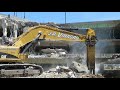 caterpillar 390dl with labounty msd7500r demolishing parking garage