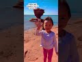 dad and daughter at red sand beach in pei shorts