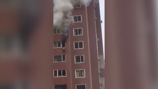 Firefighters save woman hanging outside NE China building window
