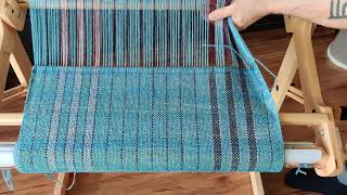 Cutting a handwoven merino, alpaca, and silk shawl from the loom