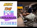 Ukrainian soldier plays the violin in front of a group of soldiers before war against Russia