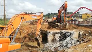 Two Doosan Excavators are demolishing existing Concrete box culvert.