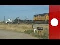 Dramatic footage: Train hits trailer truck stuck on tracks, 'Holy smokes'! says witness