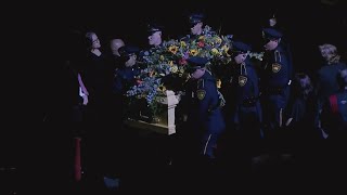 Pallbearers carry Red McCombs' casket following celebration of life