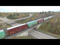 aerial view of a long cn train 305 w dpu u0026 crane at berry mills nb