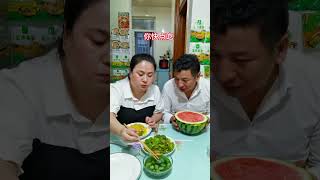 couple food One eats noodles, the other eats watermelon