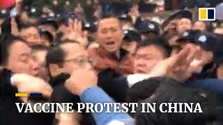 Chinese official appears to be beaten in protest over vaccine scandal