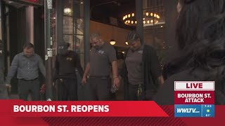 Bourbon Street workers hold an impromptu prayer